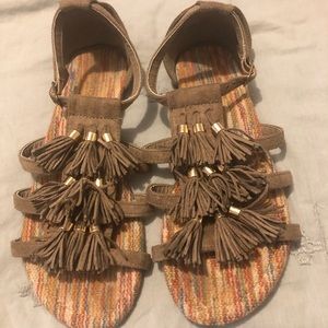 Brown and gold tassel sandals.